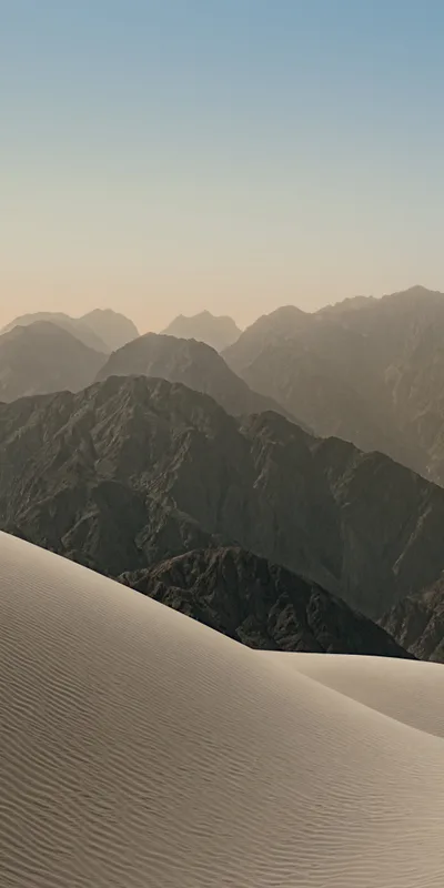 Gentle Sand Dunes Leading to Mountainous Terrain