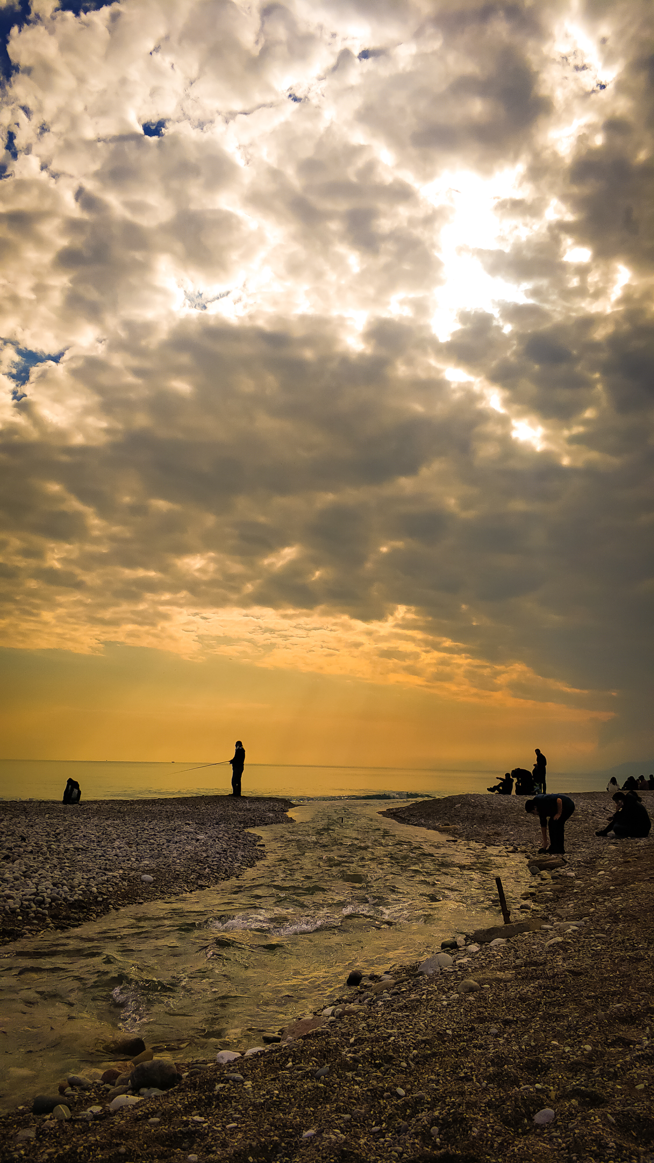 Silhouetted Figures Against a Dramatic Sunset Sky